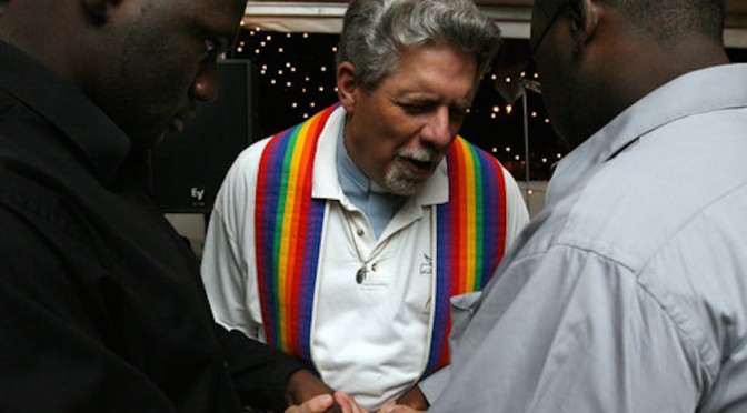 Rev. Paul M. Turner, center, blesses the union of Jeffery Hall, left, and James Nichols, right, during the Atlanta Pride Festival's commitment ceremony at the Atlanta Civic Center on July 5, 2008. The couple traveled to Atlanta from Birmingham specifically for the ceremony. Mikki K. Harris / mkharris@ajc.com